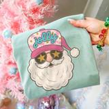 Jolly Santa DTF transfer with pink daisy trucker hat, star sunglasses, and fluffy white beard on a Christmas shirt