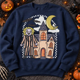 Haunted house DTF transfer with striped-suit cartoon ghoul, gothic mansion, crescent moon, flying bats, and black-and-white checkered arch Shown on a Indigo Blue crewneck sweatshirt.