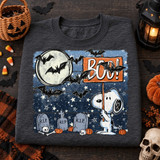 Halloween DTF transfer featuring a cartoon beagle holding a BOO! sign in a starry graveyard scene with a full moon, bats, tombstones, skulls, bones, and pumpkins Shown on a Graphite Heather crewneck sweatshirt.