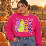 Halloween DTF transfer featuring four marker-textured ghosts in purple, lime green, orange, and pink with pumpkin, skull, skeleton, bat, and leopard print patterns surrounded by colorful stars Shown on a Heliconia crewneck sweatshirt.