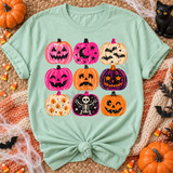 Retro block-print jack-o-lantern grid DTF transfer with nine pink, orange, and purple pumpkins featuring stars, moons, bats, a skeleton, and candy corn designs Shown on a Chalky Mint t-shirt.