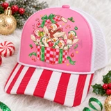 Whimsical Christmas ducks DTF transfer featuring five fluffy ducks in Santa hats and scarves popping out of a checkered gift box with candy canes and holly Shown on a Blossom pink front panel, red-and-white striped bill, soft white mesh back trucker hat.