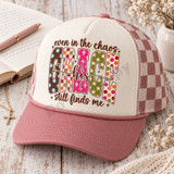 His Grace DTF transfer with bold mixed-pattern block letters spelling GRACE and hand-lettered script reading even in the chaos His grace still finds me Shown on a cream front panel with dusty rose bill and rose-brown checkered mesh back trucker hat.