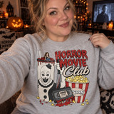 Horror Movie Club DTF transfer with killer clown holding a bloody knife, giant drink cup, popcorn bucket, and dripping Horror Nightmares VHS tape design Shown on a Ash crewneck sweatshirt.