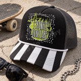 I Frankly Don't Care grunge DTF transfer with distressed lettering, neon green star splatter background, black stars, and skateboard truck graphics Shown on a Black front panel, white rope, charcoal mesh back trucker hat.