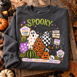 Spooky Season Halloween DTF transfer with star-print and leopard-print ghosts, checkered ghost, polka-dot and striped pumpkins, a jack-o-lantern, black cat, skull, bats, and signpost-style badge lettering reading Ghosts Ghouls & Good Vibes, Tricky or Treat, Boo Crew, and Happy Haunting Shown on a Graphite Heather crewneck sweatshirt.