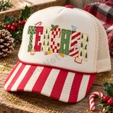 Frosted cookie-style TEACHER lettering DTF transfer with leopard print, Christmas trees, candy stripes and checkerboard patterns, surrounded by a candy cane, holly, paint palette, pencil, ruler and book icons Shown on a cream front panel with red-and-white striped bill and cream mesh back trucker hat.