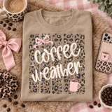 Coffee Weather DTF transfer with cream hand-lettered script, distressed leopard print background, pink bow, and steaming pink coffee mug Shown on a Hemp t-shirt.