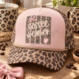 Coffee Weather DTF transfer with cream hand-lettered script, distressed leopard print background, pink bow, and steaming pink coffee mug Shown on a blush pink front panel with tan rope and brown leopard mesh back trucker hat.