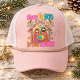 Glory To God In The Highest nativity DTF transfer with Mary, Joseph, baby Jesus, trumpeting angels, and a pastel bow on a pink striped background Shown on a Blush pink front / white mesh / tan rope trucker hat.