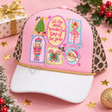 Pastel Christmas collage DTF transfer with hand-lettered 'It's the Most Wonderful Time of the Year', a Christmas tree, ballerina fairy, nutcracker, candy canes, and winking Santa face Shown on a pink front panel, white bill, gold rope, leopard mesh back trucker hat.
