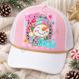 Let It Snow DTF transfer with a smiling patchwork snowman in a pink and teal striped hat and scarf, framed by a gold-glitter-style scalloped medallion with snowflakes and stars Shown on a Light Pink front panel, white bill, white mesh back trucker hat.