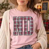 ND collegiate block letters DTF transfer filled with red, green, white, and black tartan plaid pattern and dark charcoal outline on a pink shirt Shown on a Blossom t-shirt.