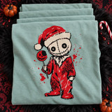 Stitched voodoo-doll Santa DTF transfer with rose tattoos, a bitten jack-o-lantern lollipop, and blood splatter detail on a shirt Shown on a Chalky Mint t-shirt.