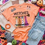 Witches Just Wanna Have Fun Halloween DTF transfer with four patterned witch hats hanging from a broomstick on a peach shirt