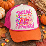 Take Me to the Pumpkin Patch DTF transfer with pink bubble lettering and three colorful decorated pumpkins featuring polka dot, daisy floral, and heart patterns Shown on a Ivory front / pumpkin orange bill / hot pink mesh trucker hat.