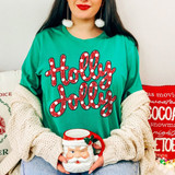Holly Jolly Christmas DTF transfer in red polka dot script lettering on a green shirt