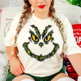 Mischievous green furry face with yellow eyes and sly grin DTF transfer, distressed Christmas character design