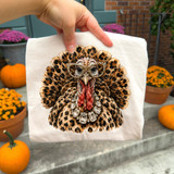 Leopard print turkey DTF transfer wearing rhinestone-inspired glasses and jeweled necklace artwork, Thanksgiving design
