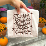 Thankful, Blessed & Mashed Potato Obsessed DTF transfer in brown script lettering with stars and pink stripe background