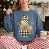 Patchwork snowman DTF transfer with buffalo plaid, leopard print, polka dot, and striped sections and gold glitter-style outline