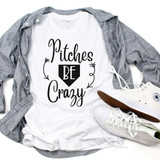 Pitches Be Crazy Baseball Sublimation Transfer, white T-shirt with black and white design and lettering, casual outfit with gray shirt and white sneakers.