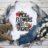 Pick flowers not fights floral word art sublimation transfer on a white T-shirt, with casual clothing and cotton branches around it.