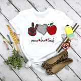 Peace love teach heart apple glitter sublimation transfer, colorful design featuring a peace sign, heart, and apple on a white T-shirt with surrounding stationery and accessories.