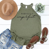 Perfectly Imperfect Screen Print Transfer, olive green sleeveless top with black script text, accompanied by a tan wide-brim hat, distressed denim shorts, brown sandals, and a small bouquet of green plants.