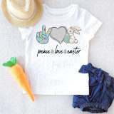 Peace Love Easter Glitter Heart Sublimation Transfer, a festive Easter-themed design featuring a glitter heart, bunny with Easter egg, peace hand sign, and Easter eggs with bold black text on a white T-shirt.