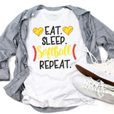 Eat Sleep Softball Sublimation Transfer, a white T-shirt with a design featuring yellow hearts with baseball stitching, game-related text, and red fern accents, laid flat with a gray shirt and white sneakers.