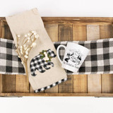 Take the Road Less Traveled Camping Travel Sublimation Transfer, decorative coffee mug with a camping scene design, and a fabric glove with a plaid bear applique, on a wooden tray with a black and white checkered cloth.
