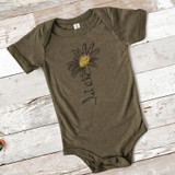 Let It Be Daisy INFANT Screen Print Heat Transfer on a baby bodysuit, khaki-colored short-sleeve baby onesie with a daisy flower and the text 'Let It Be' printed on the front.