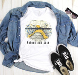 Nature and Shit Sublimation Transfer, T-shirt featuring a scenic lake, mountains, and sunrise design with text