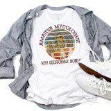 Amateur Mycologist T-Shirt with Questionable Morels, funny mushroom mushrooming sublimation transfer design on a white shirt, laid flat with gray shirt jacket and white sneakers, suitable for mushroom enthusiasts.