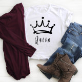 Queen Sublimation Transfer, graphic white T-shirt with a crown design and the word Queen on it, alongside denim jeans, a burgundy jacket, and brown boots, arranged on a white surface.
