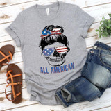 All American Skull Adult Screen Print Heat Transfer, gray T-shirt with a skull graphic featuring an American flag-themed gray visor and hair, and the phrase 'All American' in blue and red letters.