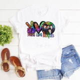 Peace Love The Beatles Fan Art Sublimation Transfer, colorful graphic T-shirt featuring the Beatles with peace symbols, and rainbow-style text with images of the band members.