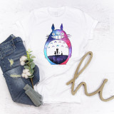 Totoro watercolor sublimation transfer, vibrant colorful watercolor depiction of Totoro character with a cosmic sky background on a white T-shirt.