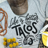 Life Is Better With Tacos Screen Print Transfer, printed design on a gray fabric t-shirt featuring a taco illustration and playful text.