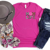 Mom Life HAT/POCKET Screen Print Transfer, pink T-shirt with 'Mom Life' text and animal print design, paired with a gray hat, floral scarf, and distressed denim jeans.
