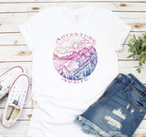 Adventure Awaits Colorful Sublimation Transfer, vibrant mountain and lake scenery design on white T-shirt.