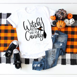 Witch Better Have My Candy Sublimation Transfer, Halloween-themed t-shirt with witch silhouette and playful text, surrounded by decorative pumpkins and Halloween accessories.
