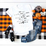 True Magic Sublimation Transfer, white T-shirt with celestial and philosophical design, paired with distressed jeans and black sneakers, surrounded by pumpkins and Halloween decorations.