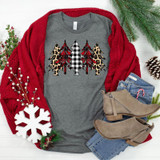 Patterned Christmas Trees Screen Print Heat Transfer, festive graphic T-shirt with holiday tree designs in black, white, red, and leopard print, displayed with red sweater, jeans, and winter accessories.
