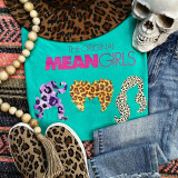 The Original Mean Girls Screen Print Heat Transfer, turquoise t-shirt with leopard print hair design and pink text, surrounded by denim jeans, leopard print shoes, a skull decoration, a bead necklace, and a leopard print hat.