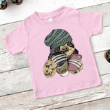 Winter Sloth YOUTH Screen Print Heat Transfer, pink toddler T-shirt with a graphic of a sloth wearing a gray beanie, holding a coffee cup and a smartphone.