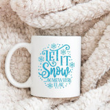 Let It Snow Somewhere Else Sublimation Transfer, white mug with blue winter-themed text and snowflake design on a soft, plush blanket.