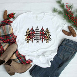 Patterned Christmas Trees Sublimation Transfer, white T-shirt with multiple Christmas tree designs featuring plaid, leopard print, and buffalo check patterns.