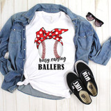 Busy Raising Ballers Baseball Sublimation Transfer, white t-shirt with a baseball graphic adorned with a red polka dot bandana and the text busy raising BALLERS, laid out with a denim jacket, sunglasses, and black Vans sneakers on a wooden surface.